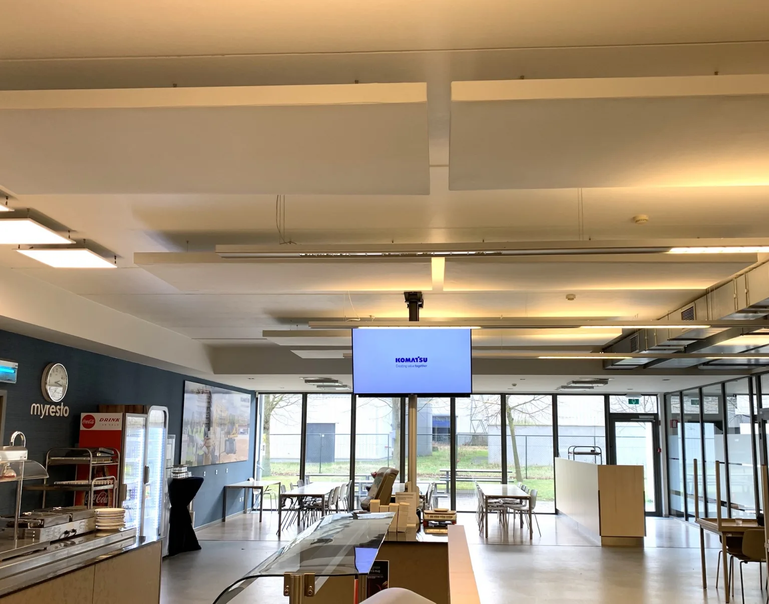 Akoestische plafondpanelen in een kantine- en breakoutruimte van een kantoor